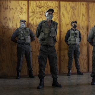 Security guards of the private security company CORTAC stand guards while briefed by their officer at one of CORTAC base before starting their night shift in Johannesburg, on February 17, 2021. - South Africa has one of the world's largest private security industries, employing more personnel than the police, according to the national Private Security Industry Regulatory Authority.
The sector creates work for more than two million people in a country where unemployment stands over 30 percent. (Photo by Michele Spatari / AFP)