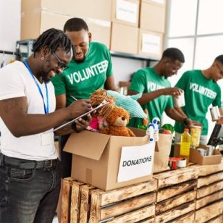 Group of young african american volunteers working at charity center.
